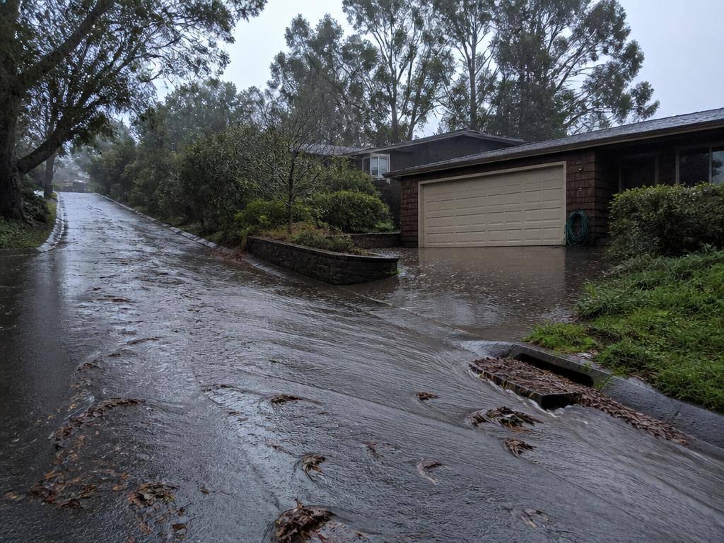 Water runs toward the house